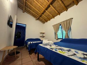 Postel nebo postele na pokoji v ubytování Finca Hotel San Cristobal Quindio