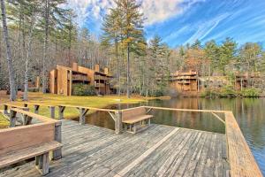 a wooden dock with benches next to a lake at Foxhunt at Sapphire Valley in Sapphire +33 photos