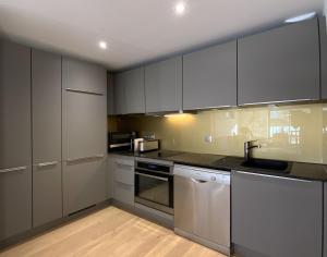 a kitchen with white cabinets and a sink at L'Escapade vintage in Eschau