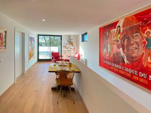 a living room with a large movie poster on the wall at L'Escapade vintage in Eschau