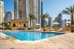 a swimming pool in a city with tall buildings at Fabulous Palm View in Dubai