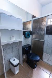 a small bathroom with a toilet and a shower at Casa 3 habitaciones Salida al Aeropuerto in San Pedro Sula