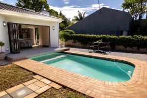 a swimming pool in the backyard of a house at Tranquility Cove in Bonza Bay in East London