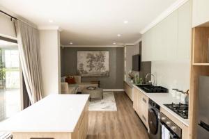 a kitchen with a counter top and a living room at Tranquility Cove in Bonza Bay in East London
