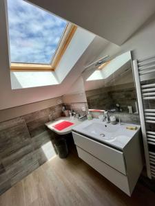 a bathroom with a sink and a large window at Charmant appartement à Roanne in Roanne +22 photos