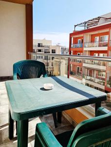a table and chair on top of a balcony at Seaside 4 in Marsaskala +16 photos