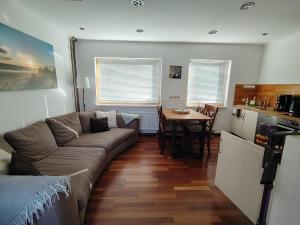 a living room with a couch and a table at Ferienhaus An der Brunnenaue in Stralsund
