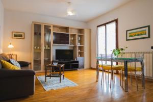 a living room with a table and a television at La casa di Tilde in Vicchio