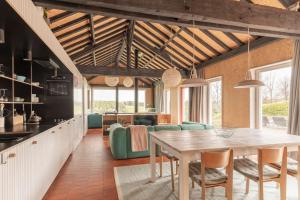 a kitchen and dining room with a table and chairs at Super view Am Flachsberg in Butgenbach