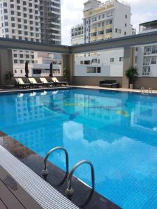 a large blue swimming pool on top of a building at Nha Trang Seaview Penthouse Apartment in Nha Trang