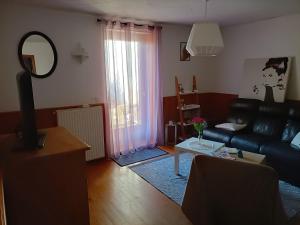 a living room with a couch and a table at a patornay maison in Patornay