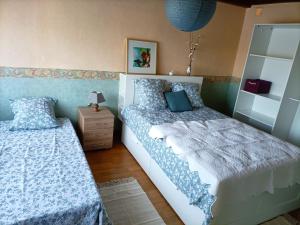 a bedroom with two beds and a night stand at a patornay maison in Patornay