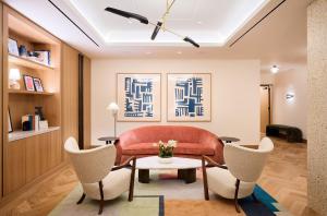 a living room with a couch and chairs at Park Terrace Hotel in New York