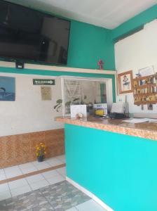 a restaurant with a blue wall and a counter at Hotel Libramiento Puerto Vallarta in Puerto Vallarta