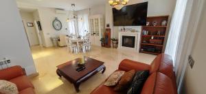 a living room with a couch and a table at LUXURY VILLA ZAGARA GOLF & Pool in Estepona