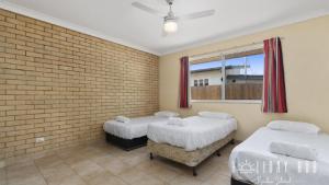 En eller flere senge i et værelse på Basic Beachside Hideaway