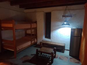 a room with two bunk beds and a light at Fundo Matufa Mancora in Canoas De Punta Sal