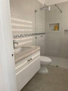 a white bathroom with a sink and a toilet at Hermoso Apartamento#4 en Unioro in Machala +2 photos