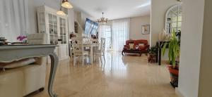 a living room with a kitchen and a dining room at LUXURY VILLA ZAGARA GOLF & Pool in Estepona