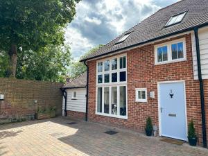 a brick house with a white door at NEW Edwin Bing Mews -Luxury City Centre Home - FREE Parking in Canterbury