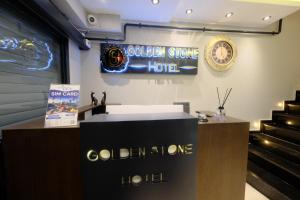 a sign for a golden stone hotel on a wall at Golden Stoneluxe İstanbul Hotel in Istanbul