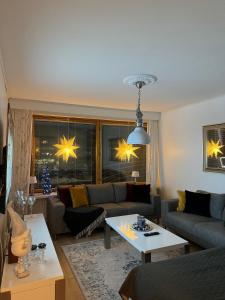 a living room with a couch and a table at Lapland Cozy Apartment in Rovaniemi +12 photos