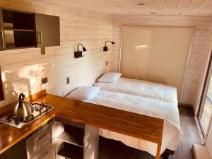a small bedroom with a bed and a stove at Terra Luna Atacama in San Pedro de Atacama