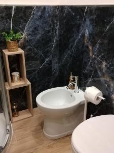 a bathroom with a white toilet and a sink at La Corte di Peretola Boutique Apartment in Florence +15 photos