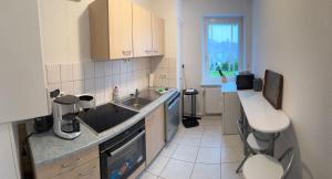 a small kitchen with a sink and a counter at Green Forest in Bad Harzburg