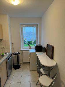 a kitchen with a table and chairs and a window at Green Forest in Bad Harzburg +11 photos