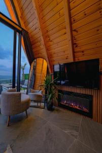 a living room with a fireplace and a tv at Ala World Resort in Kartepe