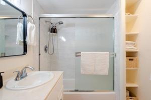 a bathroom with a sink and a glass shower at Beacons Beach Cottage in Encinitas +25 photos