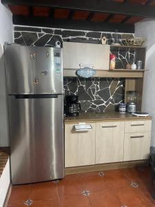 a kitchen with a stainless steel refrigerator in a kitchen at Casa Alejandro de los caballeros in Antigua Guatemala +58 photos