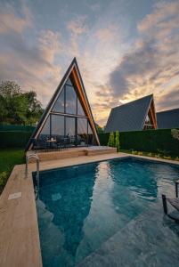 a house with a swimming pool with a building at Ala World Resort in Kartepe