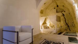 A bed or beds in a room at Giardini di Pietra