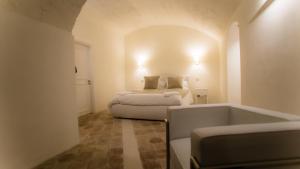 A bed or beds in a room at Giardini di Pietra