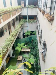 an overhead view of a building with a garden at FRONTERA 49 Roma Norte Hostal in Mexico City