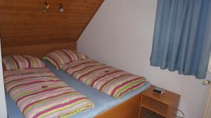 two pillows sitting on a bed in a room at Ferienwohnungen Bütow in Wismar