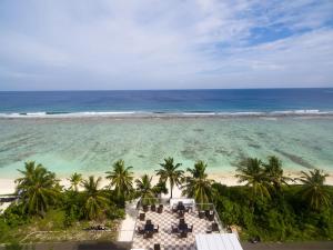 an aerial view of a beach with palm trees and the ocean at White Harp Beach in Hulhumale +32 photos