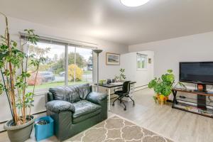 a living room with a chair and a desk and a tv at Anchorage Townhome 2 Mi to Dwtn! in Anchorage