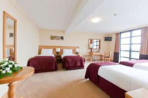 Voodi või voodid majutusasutuse Upton Court Hotel toas