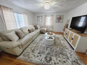 Una sala de estar con un sofá y un televisor de pantalla plana. en Cozy house, close to downtown Danvers, en Danvers