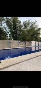 a concrete wall with a pool of water at KJT Travellers Inn in Guindulman