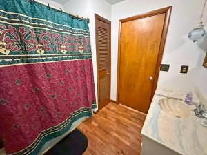 a bathroom with a red shower curtain and a sink at Buffalo Playhouse with game room in Williamson +48 photos