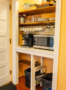 a kitchen with a counter with a microwave in it at Cottage 5-6 - 2 Bedroom / 1 Bath End Unit in Wolfeboro