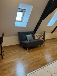 a living room with a couch in the attic at L'écume des jours in Colmar