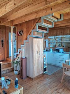 a kitchen with a staircase in a wooden house at Condominio Don Alberto in Pichilemu +26 photos