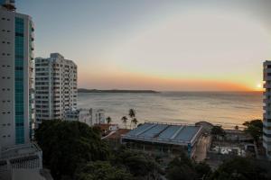 a view of the ocean from a city at sunset at Apartamento Unik Cartagena Edificio Poseidón in Cartagena de Indias