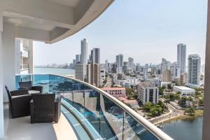a balcony with chairs and a view of the city at Apartamento Unik Cartagena Edificio Poseidón in Cartagena de Indias