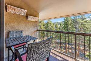a balcony with a table and chairs and a view at Rocky Mountain Mama in Breckenridge